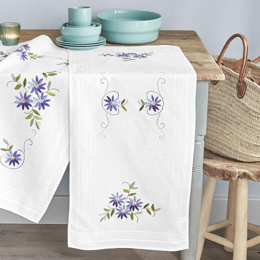 Tischläufer mit blauem Sternenstickerei und Geschirr auf einem Tisch