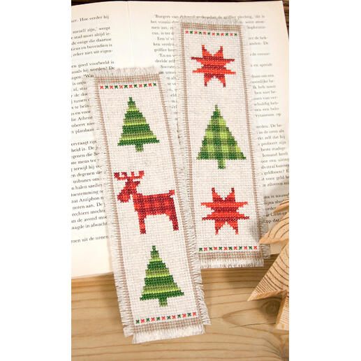 Lesezeichen-Set mit Weihnachtsmotiven auf einem offenen Buch.