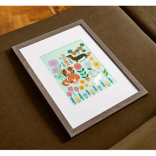 Kreuzstich Set mit einem bunten Hundemotiv in einem Rahmen.