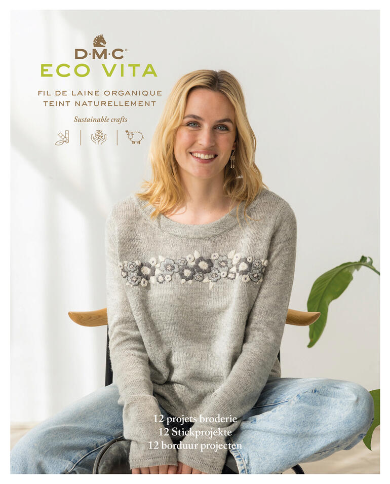 Buchcover 'Eco Vita' mit einer lächelnden Frau in handbesticktem Pullover.