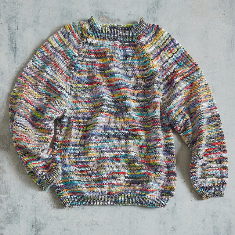 Bunter Kinderpullover aus Merino-Print mit langem Arm und Rundhalsausschnitt.
