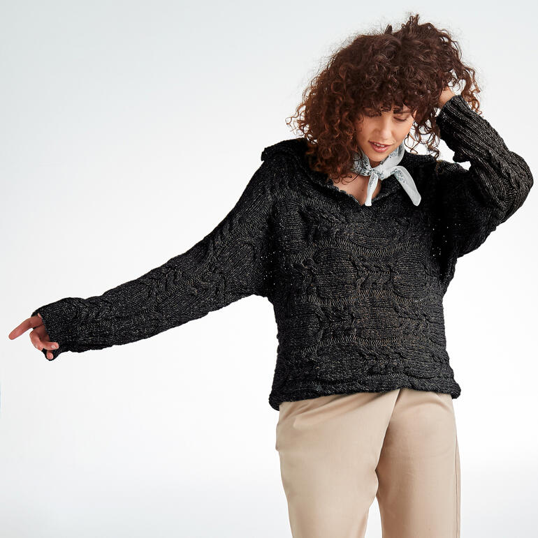 Frau trägt einen schwarzen Pullover mit strukturiertem Muster