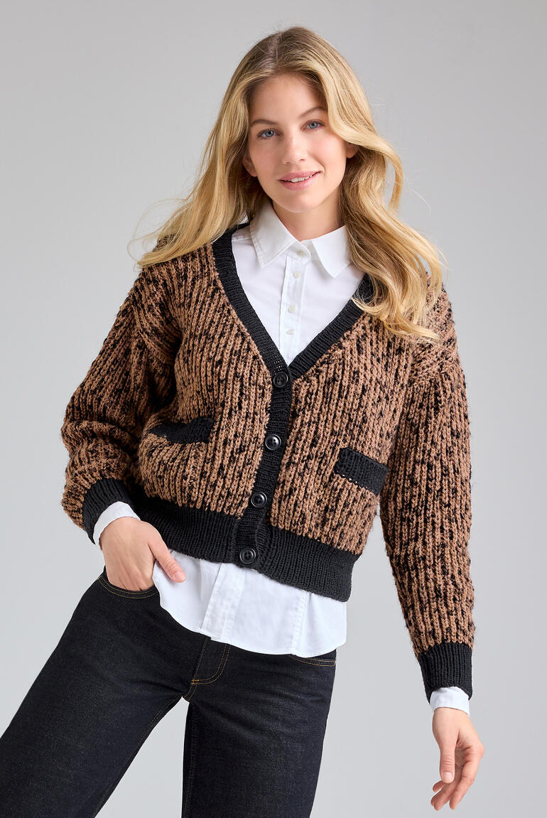 Frau in einer gemusterten Jacke aus Animals und Merino-Extrafein, lächelnd