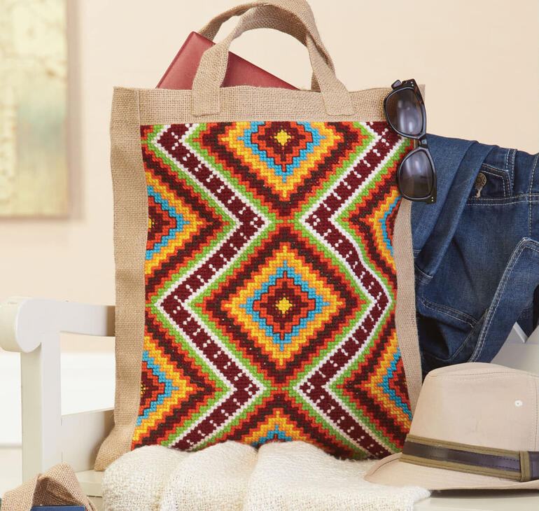 Jute-Tasche mit buntem Berber-Muster und robusten Griffen.