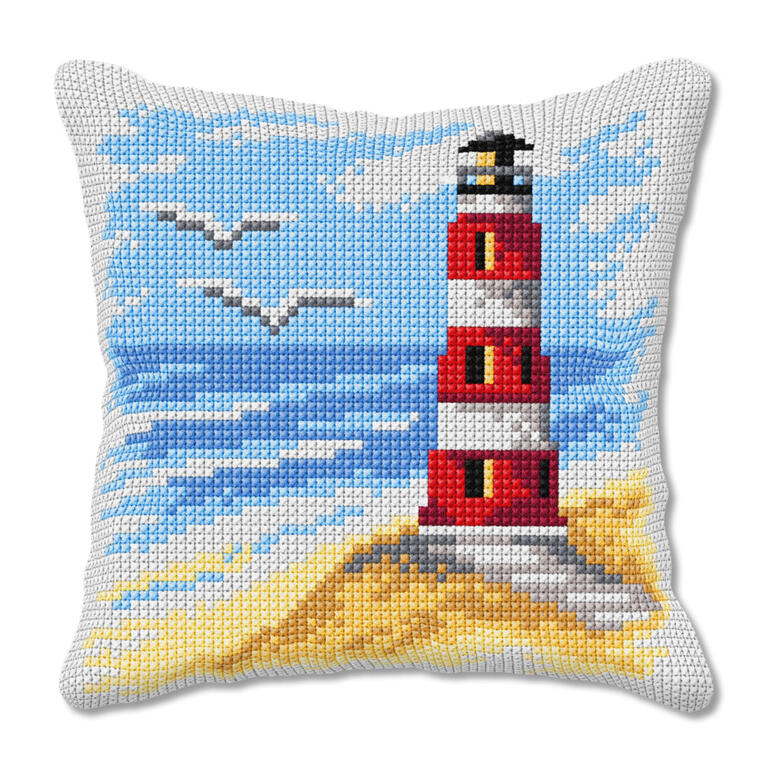 Kreuzstichkissen mit Leuchtturm und Küstenlandschaft.