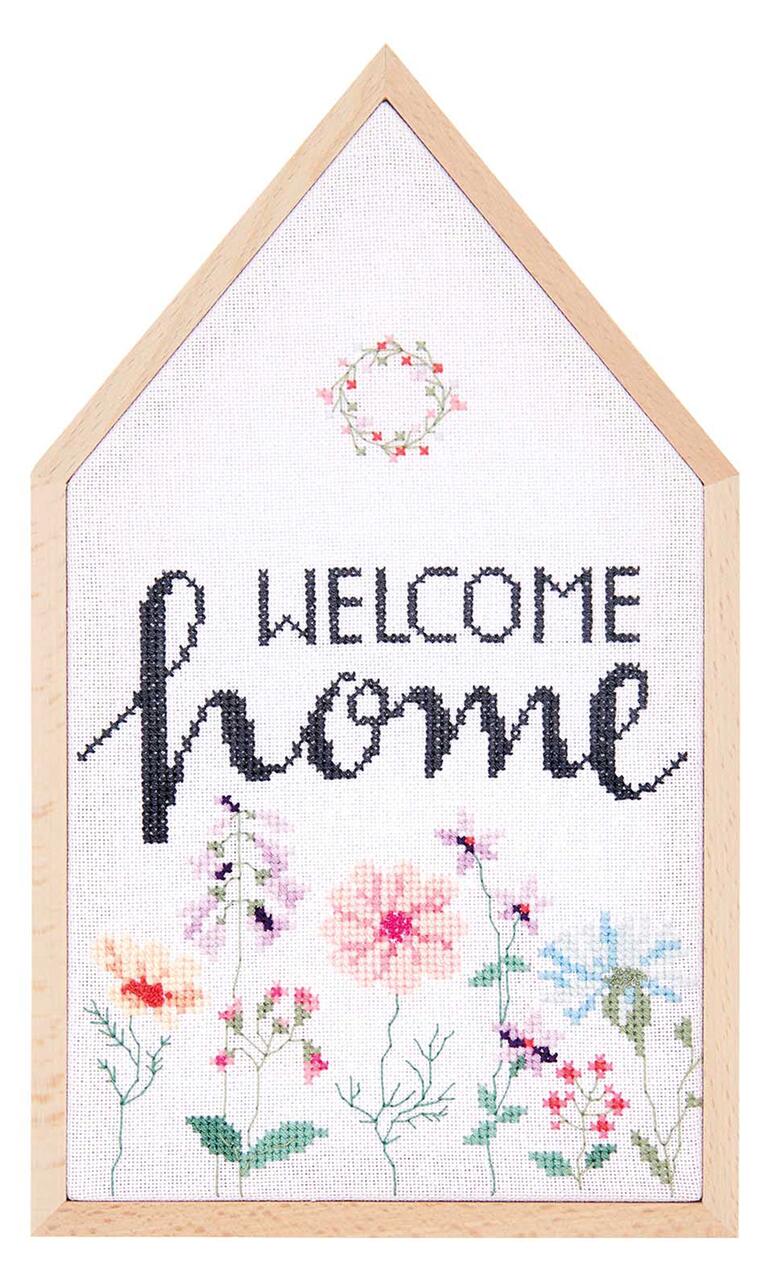 Kreuzstichbild mit dem Schriftzug 'Welcome Home' und Blumenmotiven.