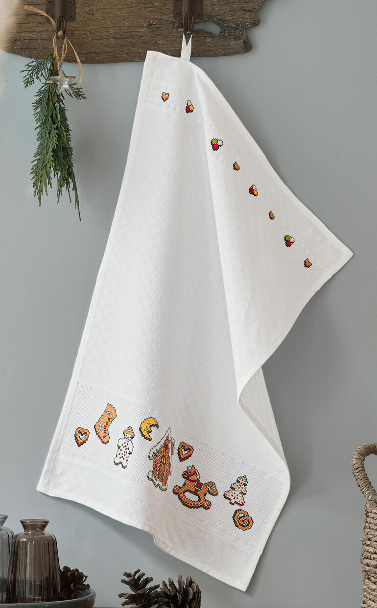 Geschirrtuch mit lebkuchenförmigen Motiven an der Kante