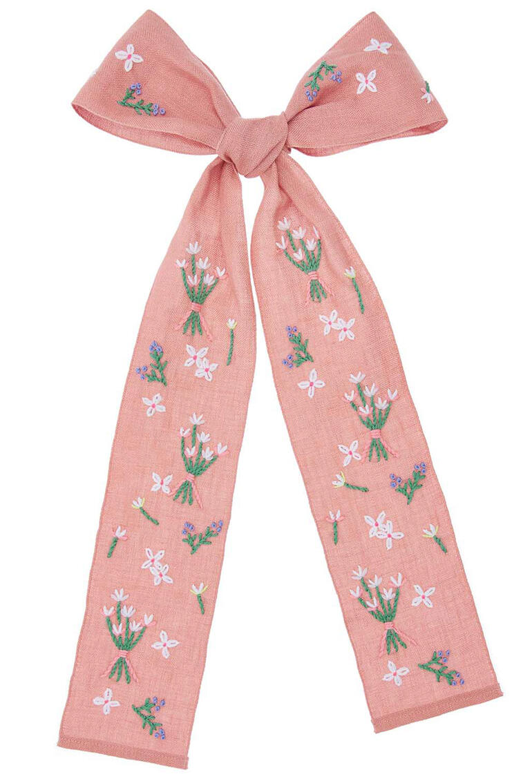 Schleife mit Frühlingsblümchen-Motiv in sanften Farben, ideal als Haar- oder Dekorationsschmuck.